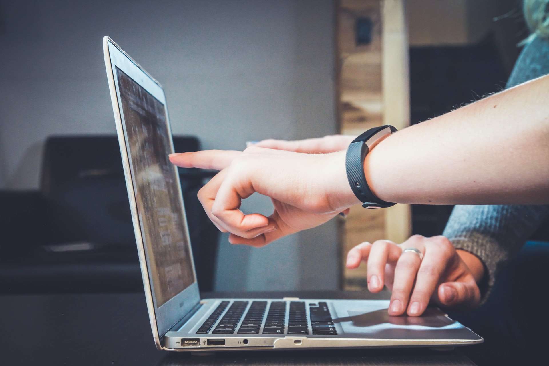 Person pointing at laptop screen wondering if automation is worth it